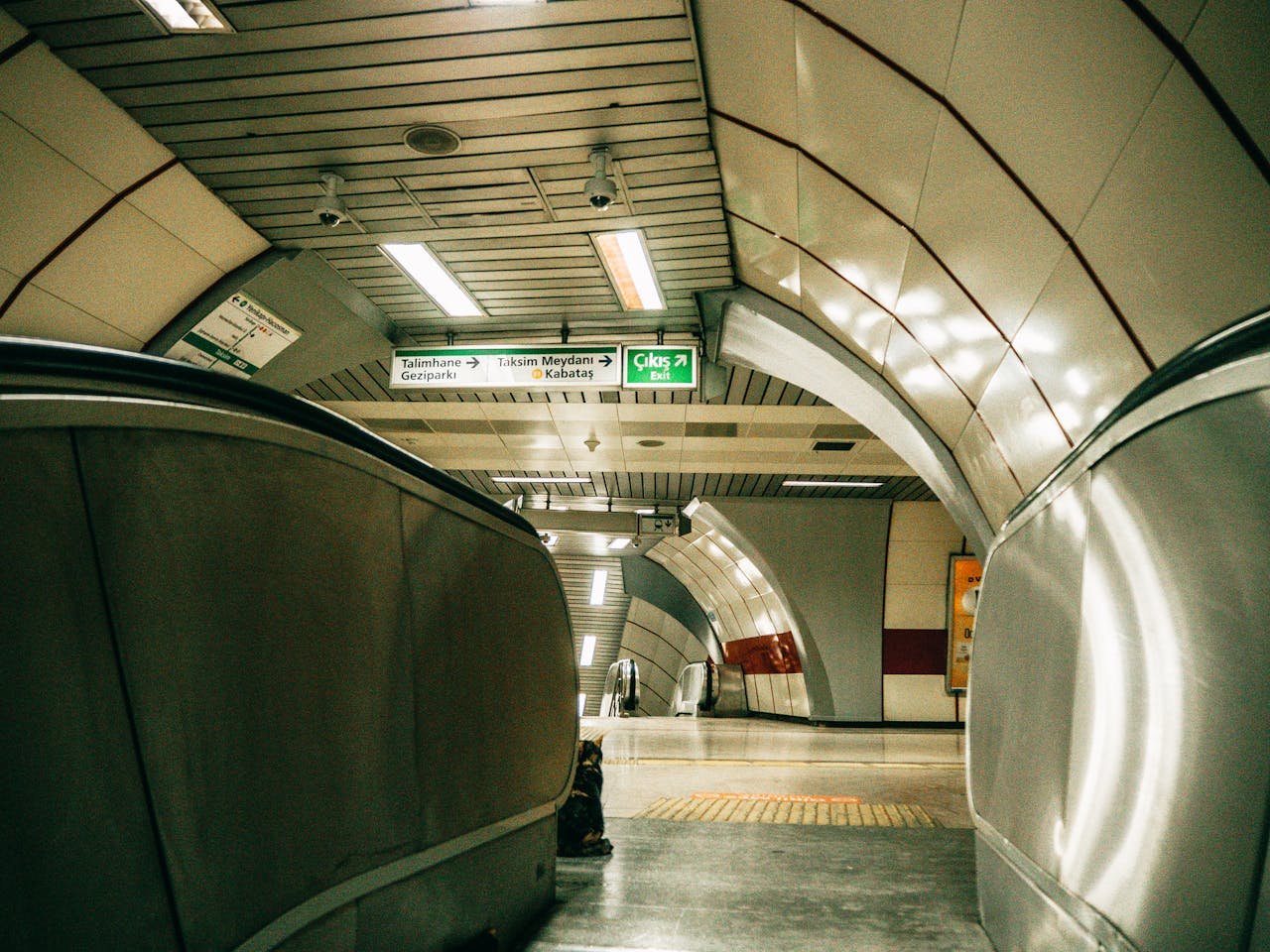 Explore the detailed architecture and design of an Istanbul metro station with escalators and signage.